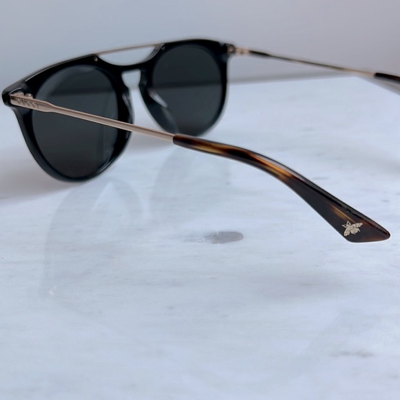 Gucci Women Aviator Sunglasses in black with gold trim. main image 5